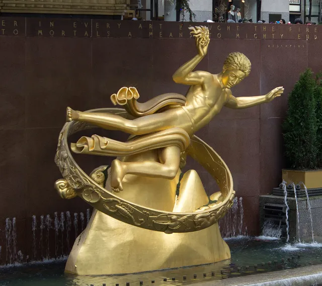 Rockefeller Center's gilded Prometheus reclining above his fountain, delivering fire to mortals exactly as the inscription behind him promises.